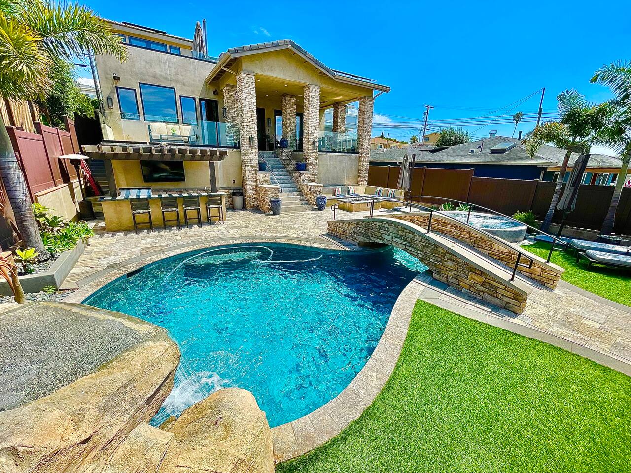Poolside terrace with outdoor bar and multi-level decking